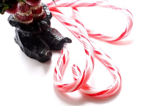 Wooden carving of elf slippers and candy canes