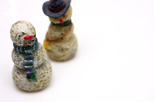 A couple of wooden snowmen on white background