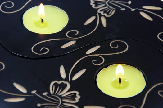 two yellow candles on fire closeup