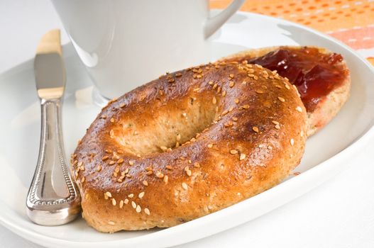 Toasted sesame seed bagel served with strawberry jam.