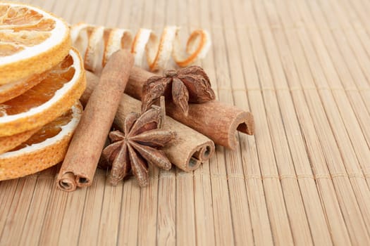 detail of Star Anise, cinnamon and dried orange  on wooden background 