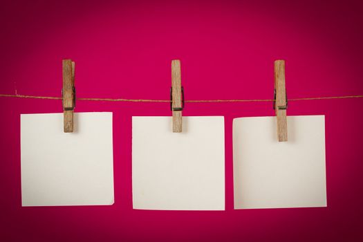 memory note paper hanging on cord on red background