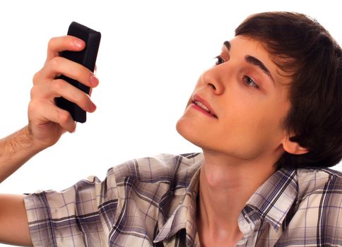 Young man types sms holding phone in hands on white background