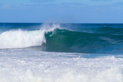 These monster waves are coming in by the set and standing over 20 feet tall. The surf is dangerous and the waves are very intimidating but there is a competition for surfers happening at the same time.