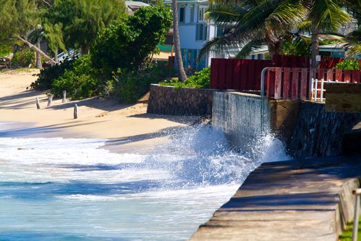 Giant waves pound this storm sea wall on the north shore of Oahu Hawaii during a storm in tropical paradise.