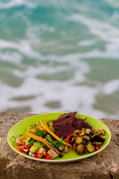 This simple meal of fish tacos is served with some roasted veggies and chips on a green plate in Hawaii.