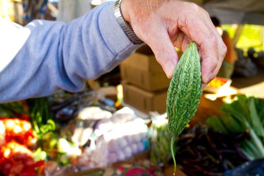 Images from a farmers market in Hawaii showing tropical fruits or vegetables in simple photos with vibrant colors.