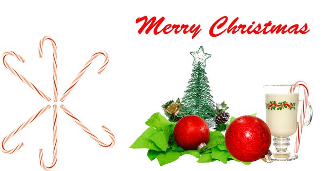 A Christmas celebration decoration of eggnog a Christmas tree, candy canes, and ornaments on white.