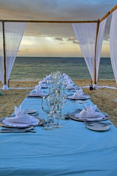 Exterior place setting for ocean side wedding celebration