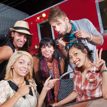 Cute men and women sitting in front of food truck