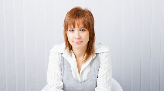 blue-eyed attractive young businesswoman in office