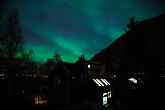 Northern lights shine brightly over a home