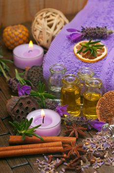 Spa concept with massage oils, aromatic lavender, spices, candles and cotton towels