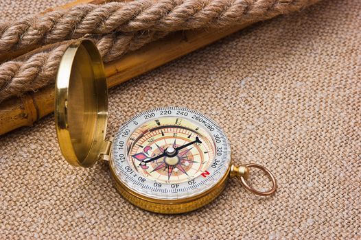 Compass with a rope on the background of the old pattern