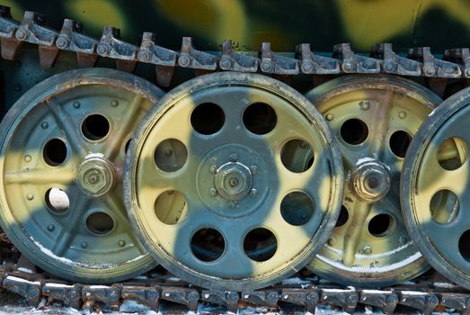 Old Russian green tank 's tracks and iron wheels