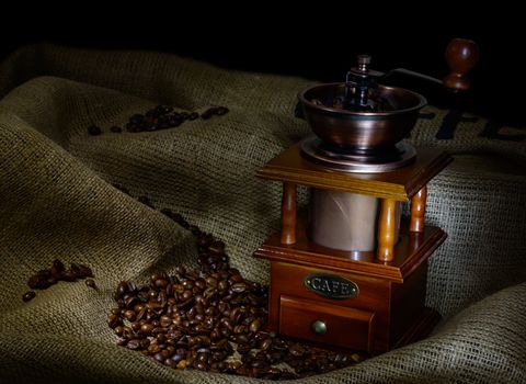 Coffee Mill with beans and burlap. still life