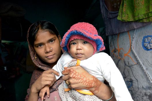 New Delhi,India-February 4, 2013: a young Indian mother with her child who lives in the poorest district of New Delhi in February 4,2013.50% of the population of New Delhi is thought to live in slums