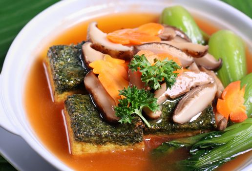 Asian braised tofu and vegetable dish in claypot