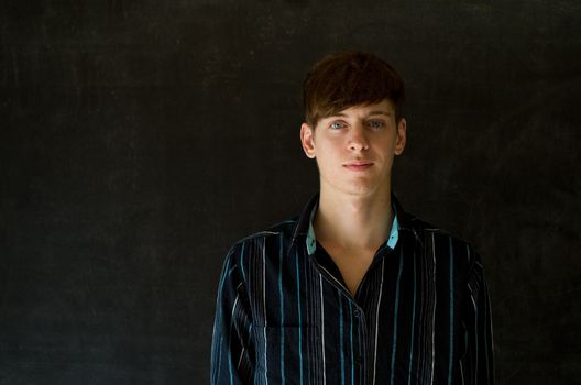 Confident man against a blackboard background