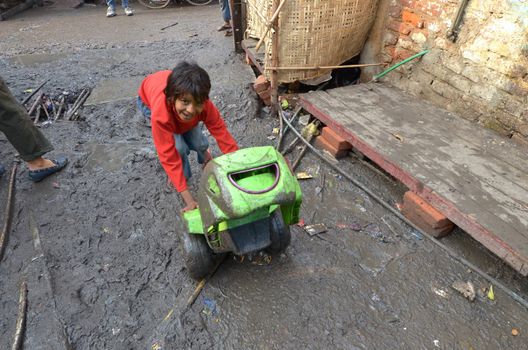 New Delhi,India-February 4, 2013:a  unidentified child playing the poorest district of New Delhi in February 4,2013 New Delhi dramatically increases the number of poor people living in slums