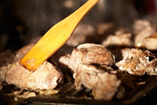Nice pieces of meat are fried on the barbecue. Shallow dof.