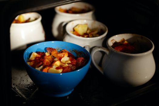 Mutton meat and potatoes, baked in pot.