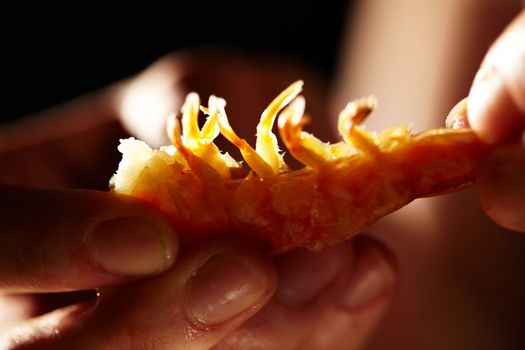 Shrimp in hands. Macro shot with beautiful backlight. Horizontal shot.