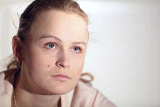 Young woman is watching an interesting film on tv. Close up shot.