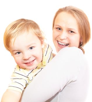Young mother with her son are hugging and laughing. Focus is on the mother's face. Shallow dof. Isolated on white.