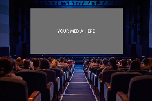 Empty cinema screen with audience. Ready for adding your picture. Screen has crisp borders. This shot was made using tripod with long exposure.