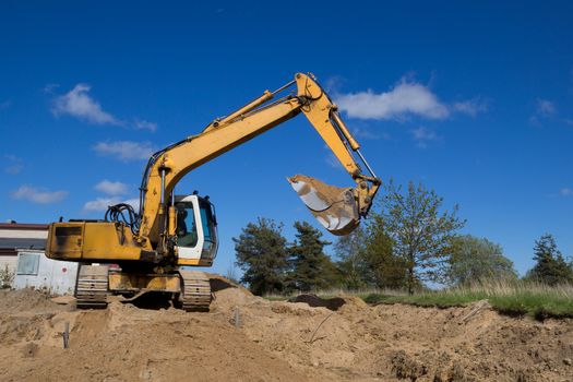 big yellow excavators working on a construction site
