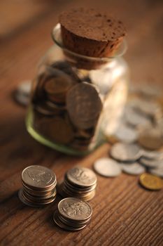 old coins on the wooden table, shallow dof