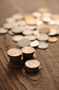 old coins on the wooden table, shallow dof