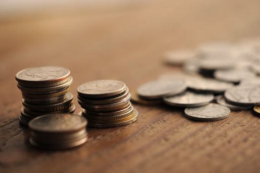 old coins on the wooden table, shallow dof