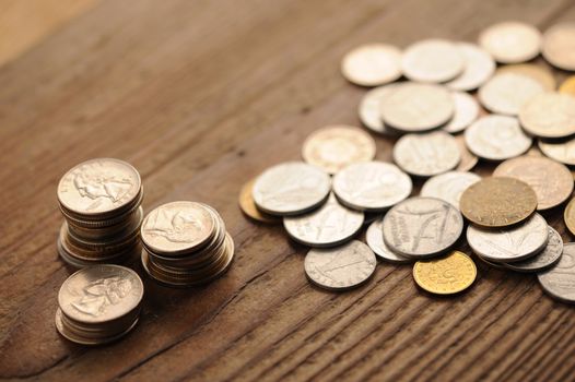 old coins on the wooden table, shallow dof