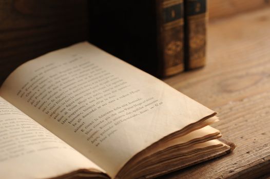 old book open on a wooden table