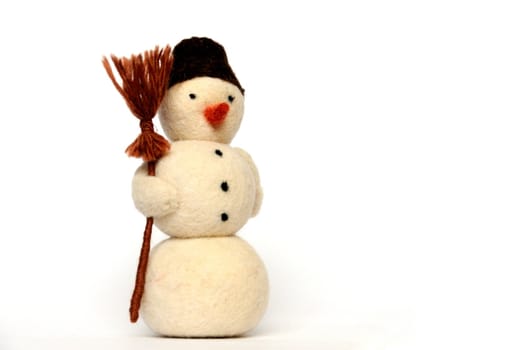 toy - a cheerful snowman with broom on white background, close-up