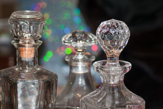 crystal glass whiskey bottles on reflective background