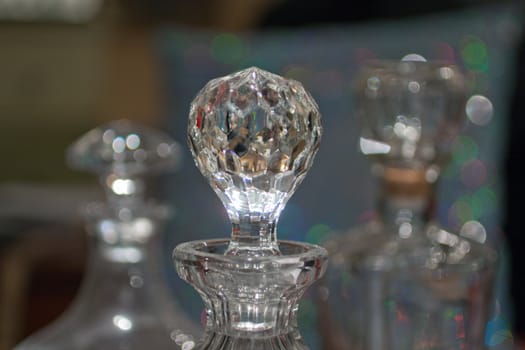 crystal glass whiskey bottles on reflective background