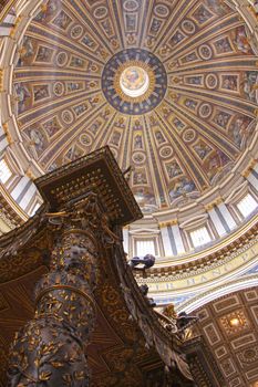 The dome of St. Peter's Basilica with the top of the baldachin in the bottom of the frame.