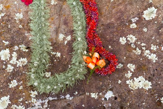 These beautiful flower leis have been placed on the birthing stones in Hawaii on the north shore of Oahu. These historical rocks are the site of where many native queens and kings have been born in the past.