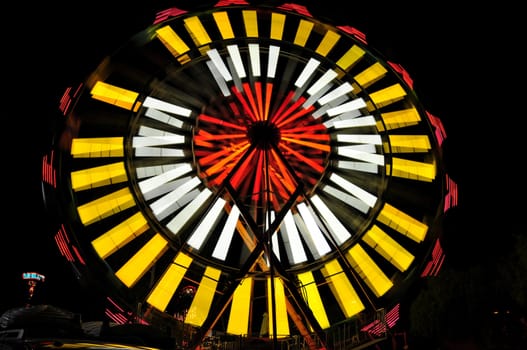 View of a spinning carnival ride at night in Temecula, California.