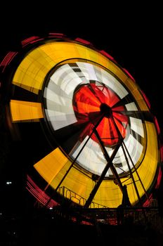 View of a spinning carnival ride at night in Temecula, California.