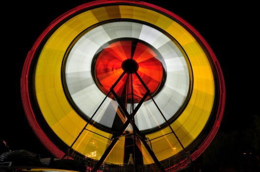 View of a spinning carnival ride at night in Temecula, California.
