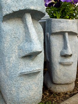Easter Island Planters with Purple Flowers Growing