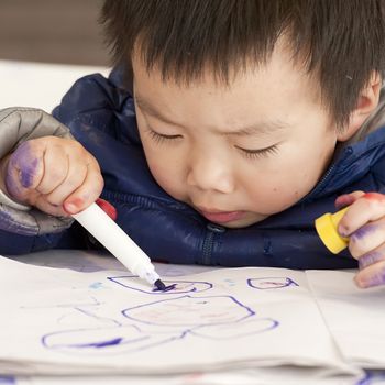 a cute baby is painting