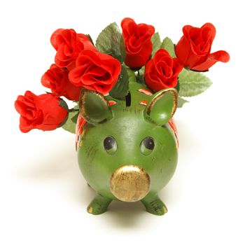 A pig bank and red roses represent the love of money.