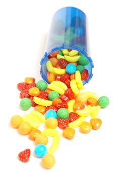 A conceptual image of candy spilling from a pill bottle to be mothers little helper.