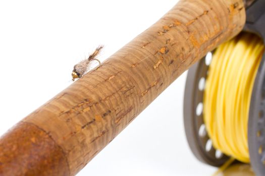 A hares ear bugger nymph is photographed in a lighting studio with a white background while rigged up and ready to fish on this fly rod and reel setup.