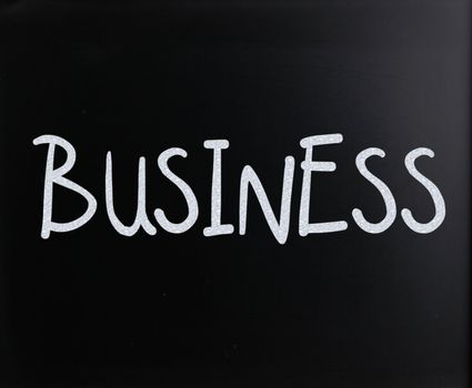 The word "Business" handwritten with white chalk on a blackboard